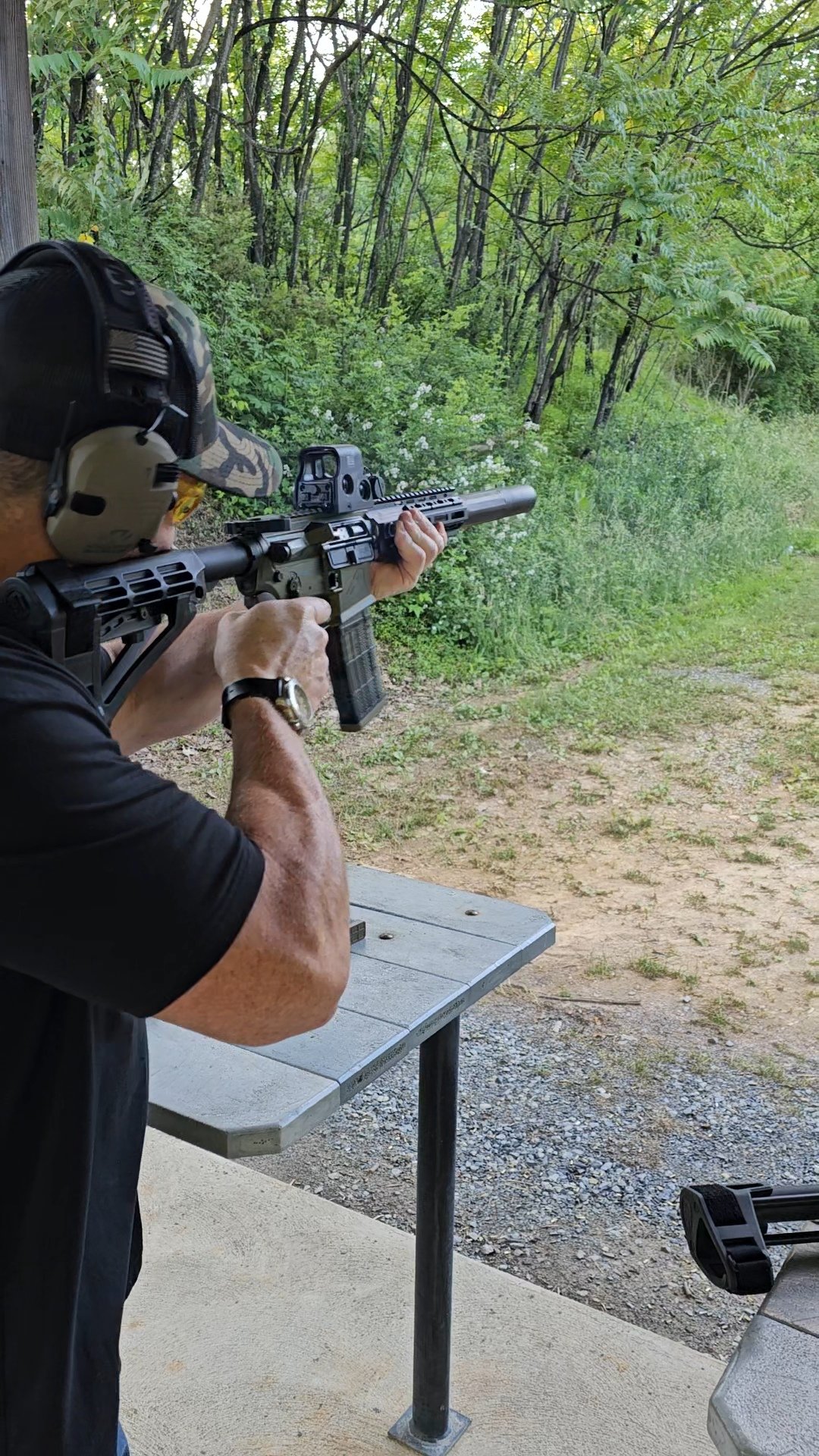 Man shooting an AR15 with the American Animal Lights Out Rail at the shooting range